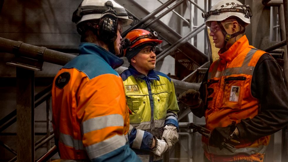 Three men having a conversation