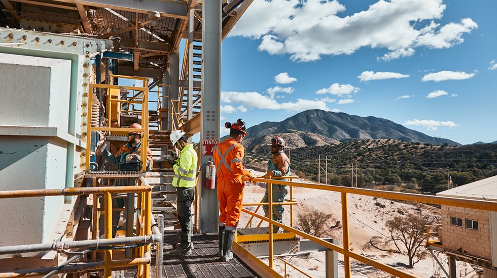 Three men talking at the Milpillas site.