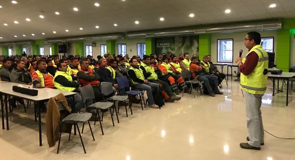 Mill maintenance people in a room listening to an instructor.