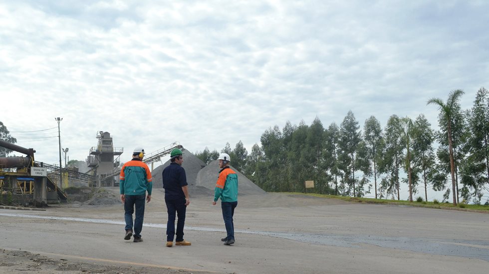 Three people walking at a quarry.