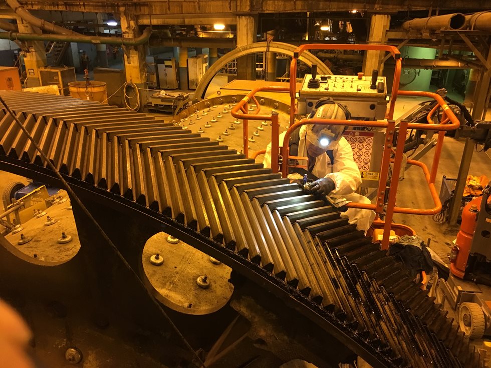 Metso Outotec expert inspecting a grinding mill gear