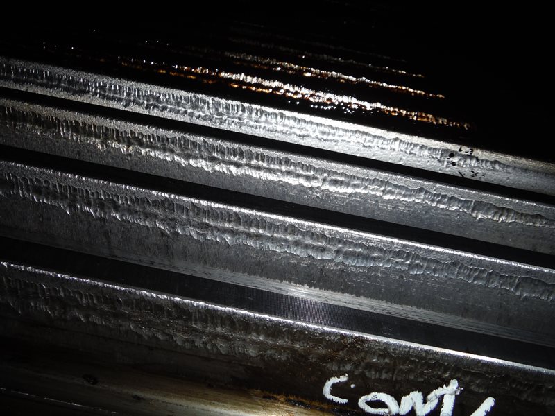 Lubrication system failure: Gear ran dry, reaching metal fusion temperature causing metal transfer from the gear to the pinion teeth, giving the appearance of weld passes