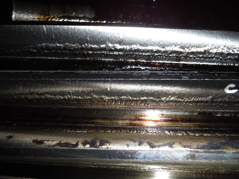 Lubrication system failure: Gear ran dry, reaching metal fusion temperature causing metal transfer from the gear to the pinion teeth, giving the appearance of weld passes