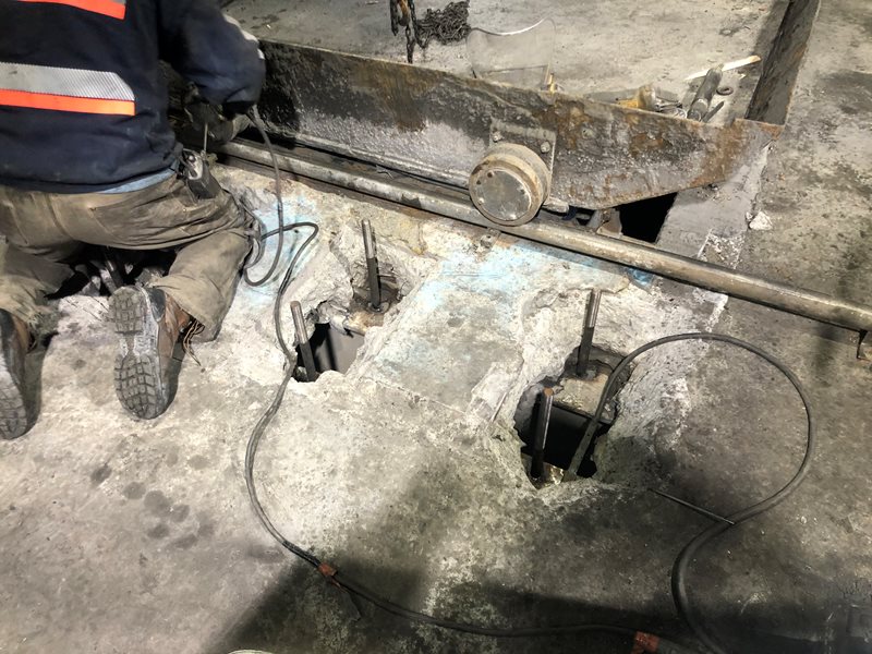 New anchor bolts welded to underlying structural beams.