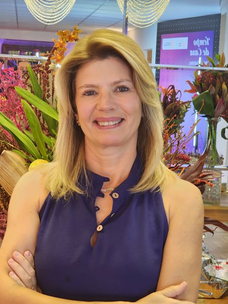 Paula Peres smiling at the camera.