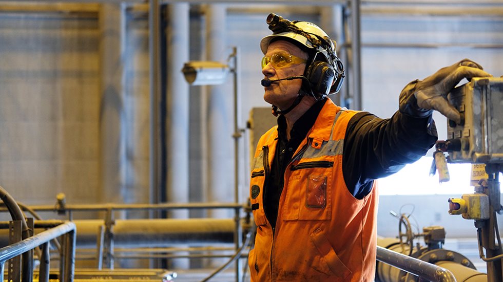A man controlling equipment in a mine. 