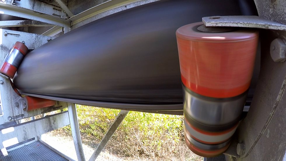 Pipe shaped conveyor belt clearly showing the overlap at the bottom and no spillage below