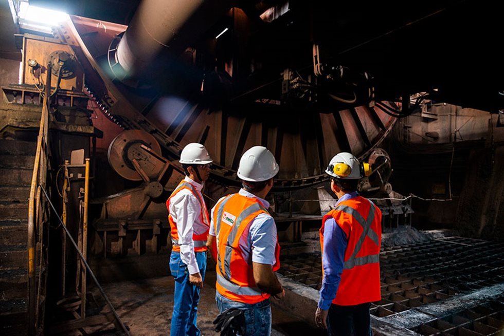 Three people looking at the wagon tippling solution. 