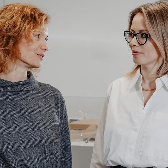 Two Metso employees discussing at an open office space.